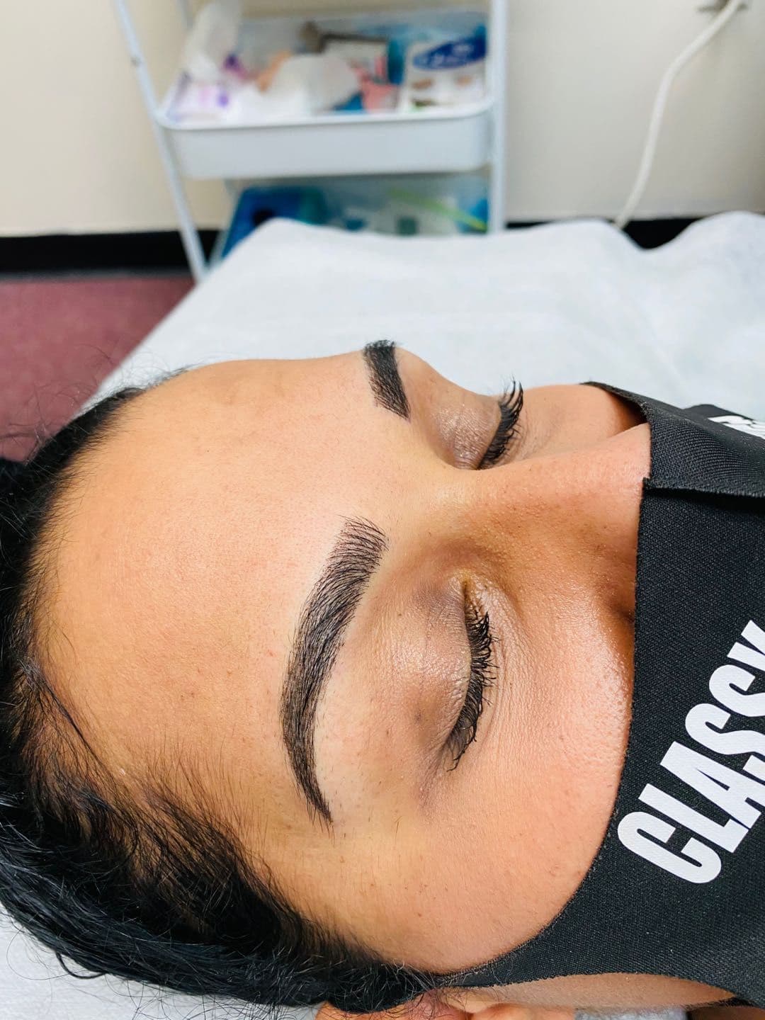 Client eyebrow result with a soft arch and natural hair texture